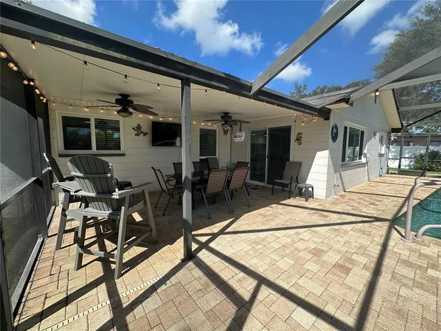 a view of a patio with table and chairs