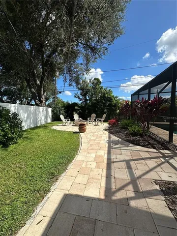 a view of yard with patio