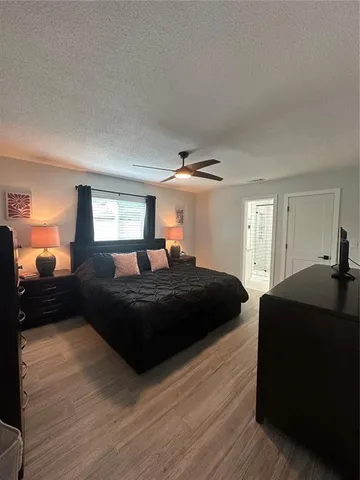 a bedroom with a bed window and a dresser