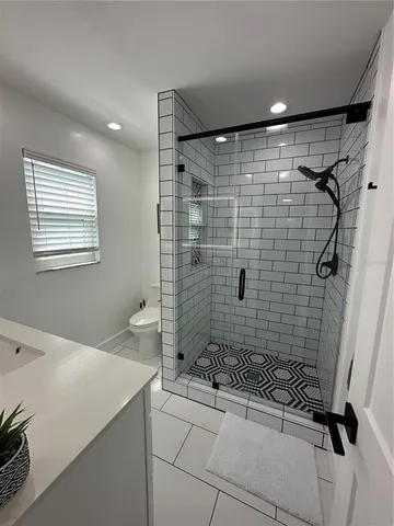 a bathroom with a shower and a sink