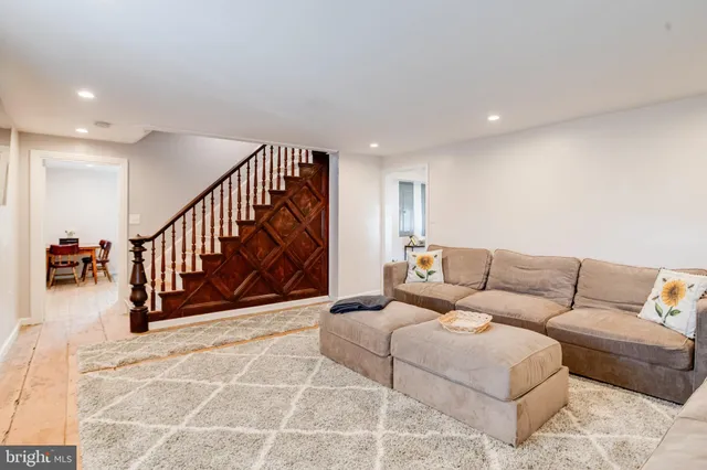 a living room with furniture and floor to ceiling windows