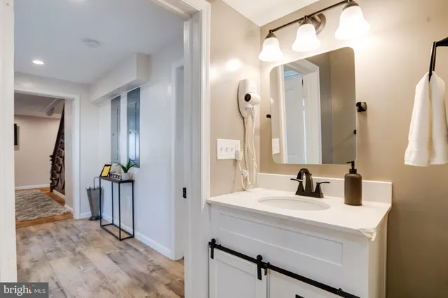 a bedroom with a large bed and a lamp