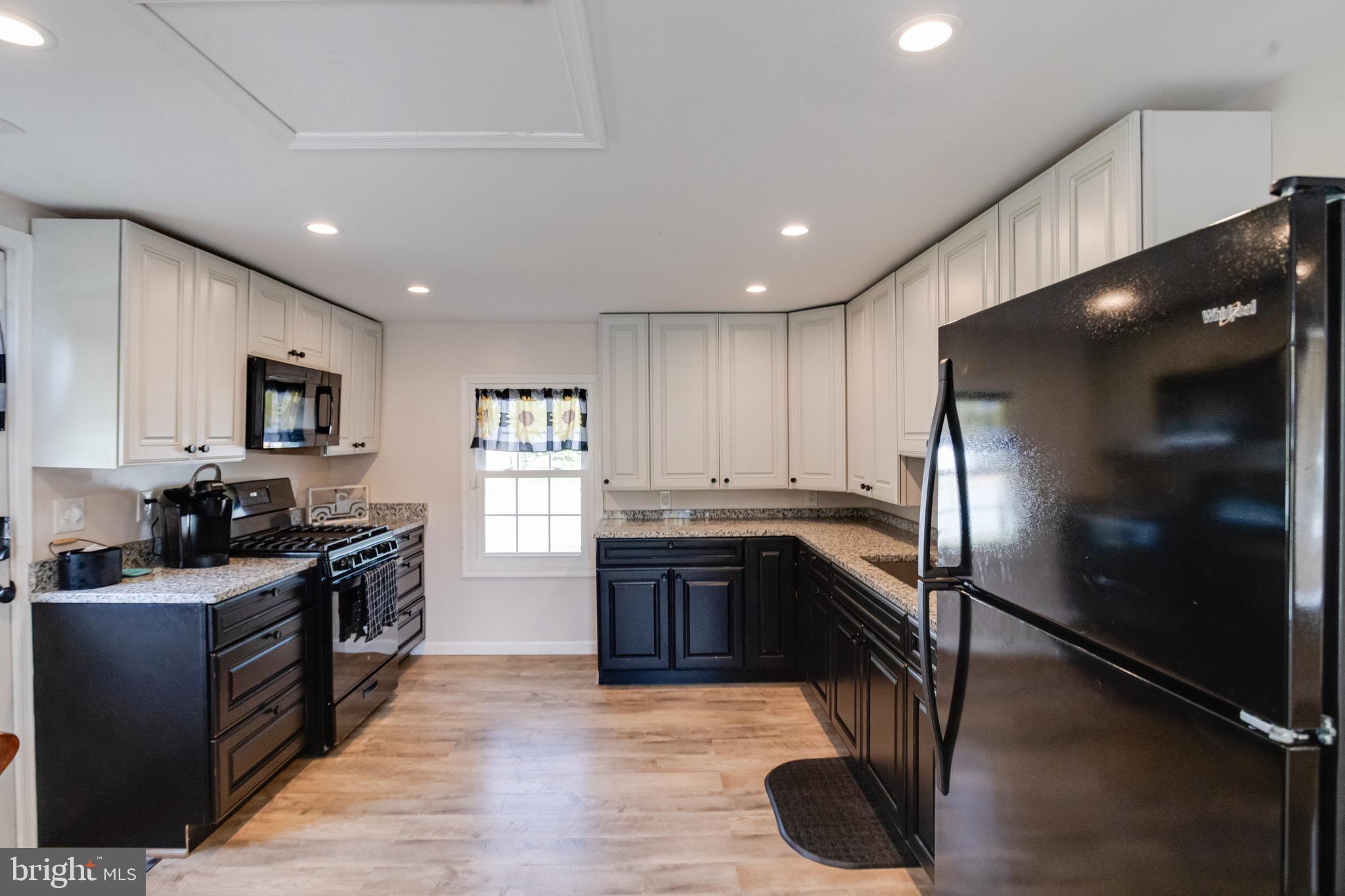 203 Blythedale Road Perryville, MD 21903 - Photo 40 of 104 a kitchen with stainless steel appliances granite countertop a stove a sink and a refrigerator
