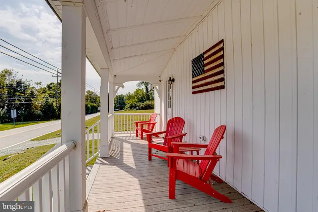 a view of balcony with wooden floor and outdoor seating