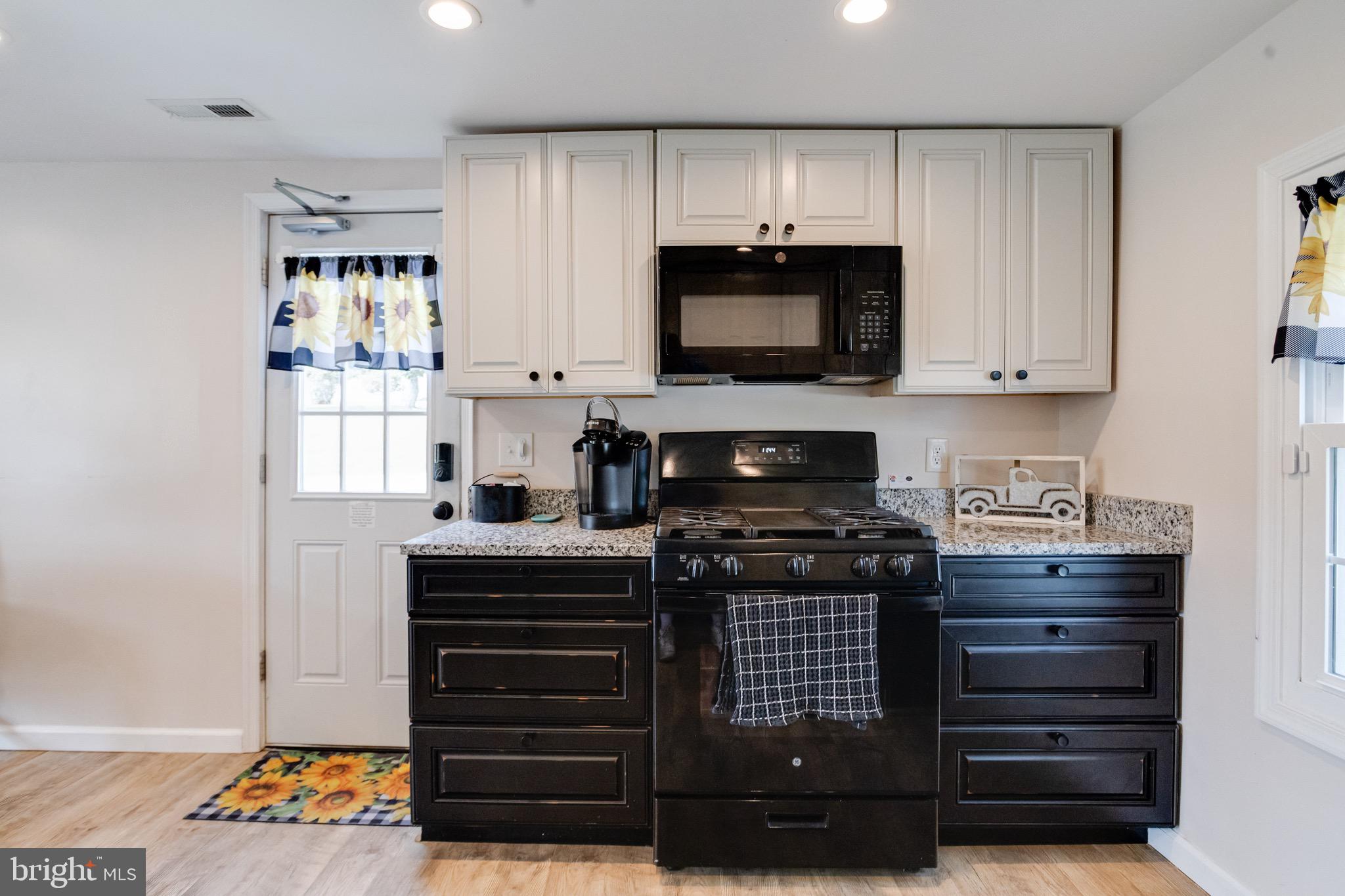 203 Blythedale Road Perryville, MD 21903 - Photo 44 of 104 a kitchen with stainless steel appliances a stove a microwave and cabinets