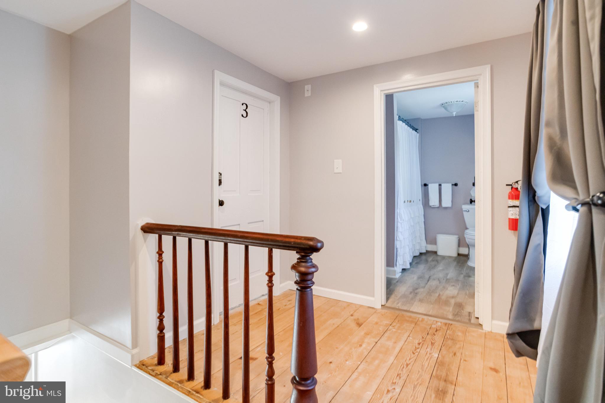 203 Blythedale Road Perryville, MD 21903 - Photo 49 of 104 a view of a hallway with wooden floor and a bathroom