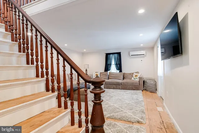 a view of a livingroom with furniture and staircase