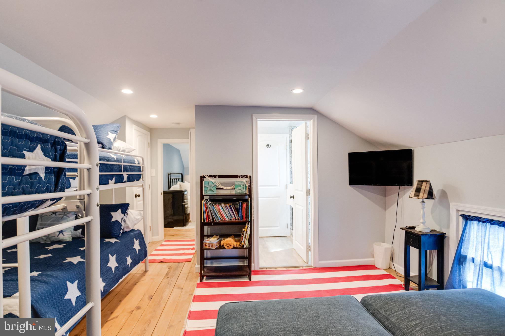 203 Blythedale Road Perryville, MD 21903 - Photo 81 of 104 a living room with a bookshelf and a flat screen tv