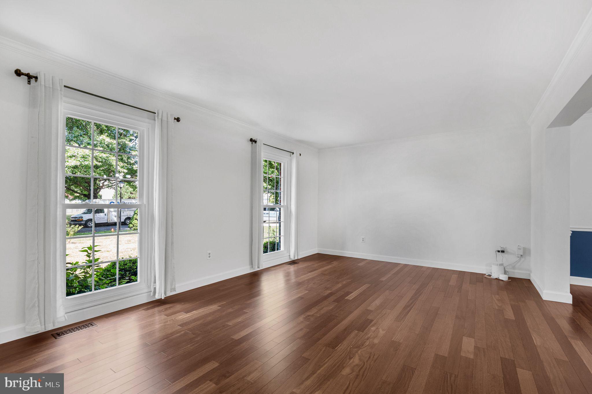 14422 Pebblestone Drive Silver Spring, MD 20905 - Photo 11 of 37 an empty room with wooden floor and windows