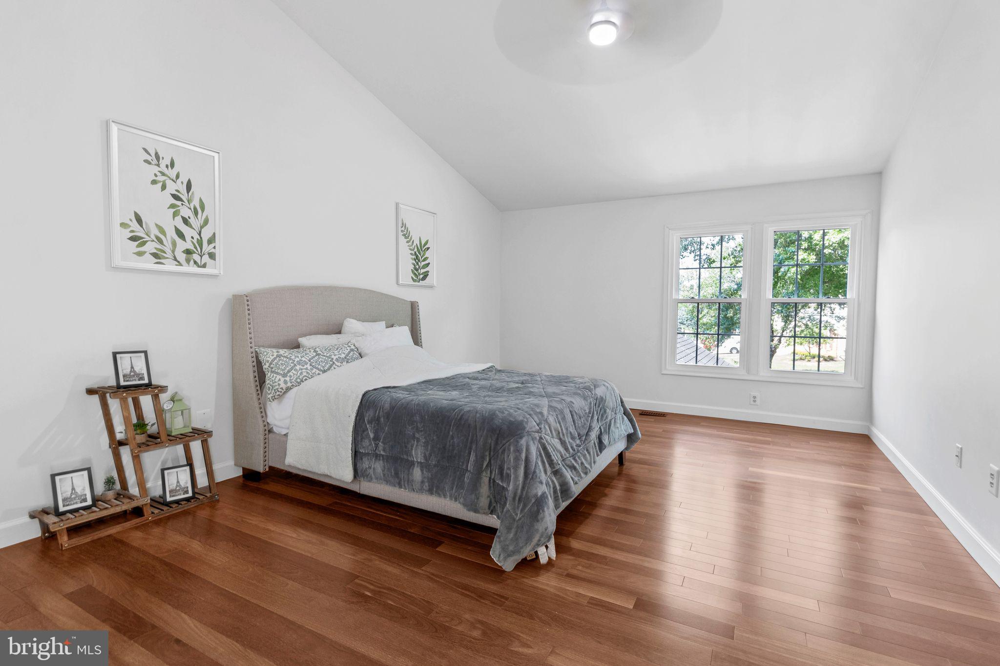 14422 Pebblestone Drive Silver Spring, MD 20905 - Photo 15 of 37 a bedroom with a bed painting on wall and windows