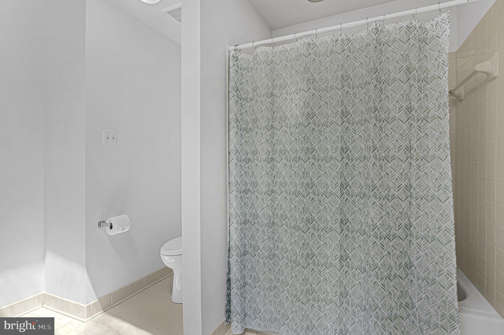 14422 Pebblestone Drive Silver Spring, MD 20905 - Photo 19 of 37 a bathroom with a granite countertop shower and a toilet