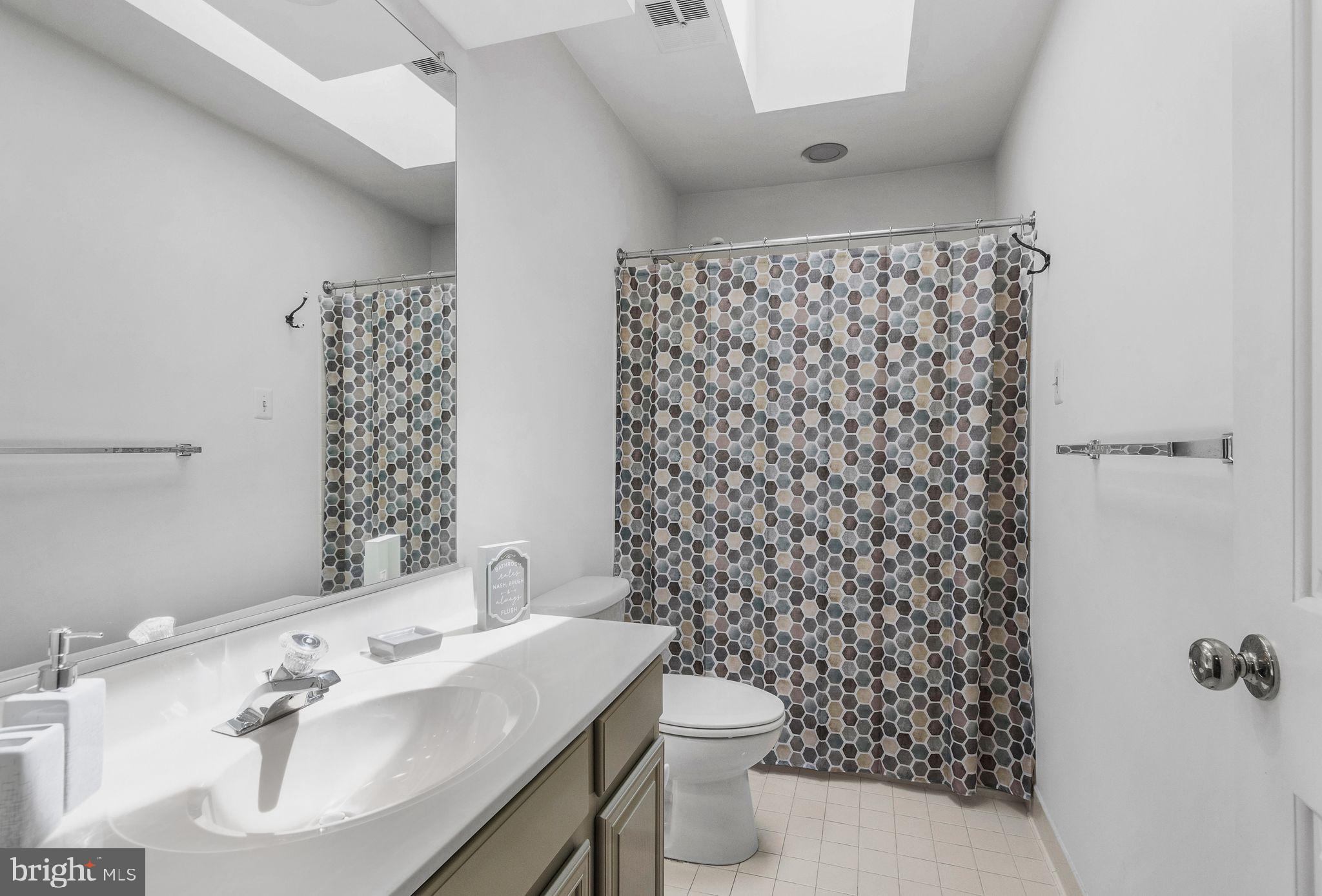 14422 Pebblestone Drive Silver Spring, MD 20905 - Photo 22 of 37 a bathroom with a sink toilet and shower