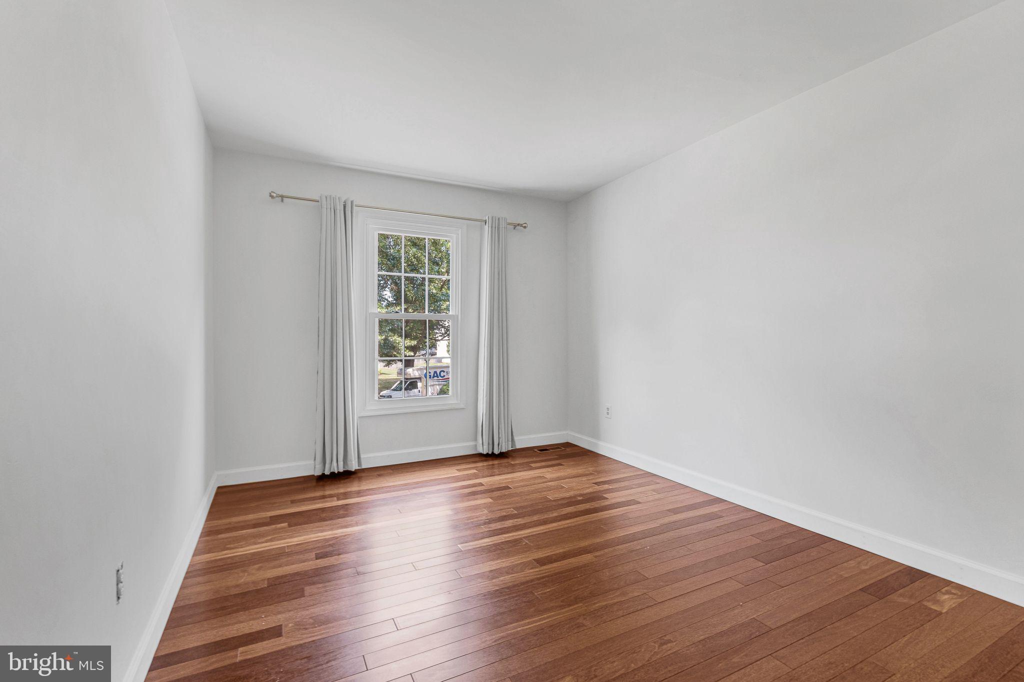 14422 Pebblestone Drive Silver Spring, MD 20905 - Photo 24 of 37 an empty room with wooden floor and windows