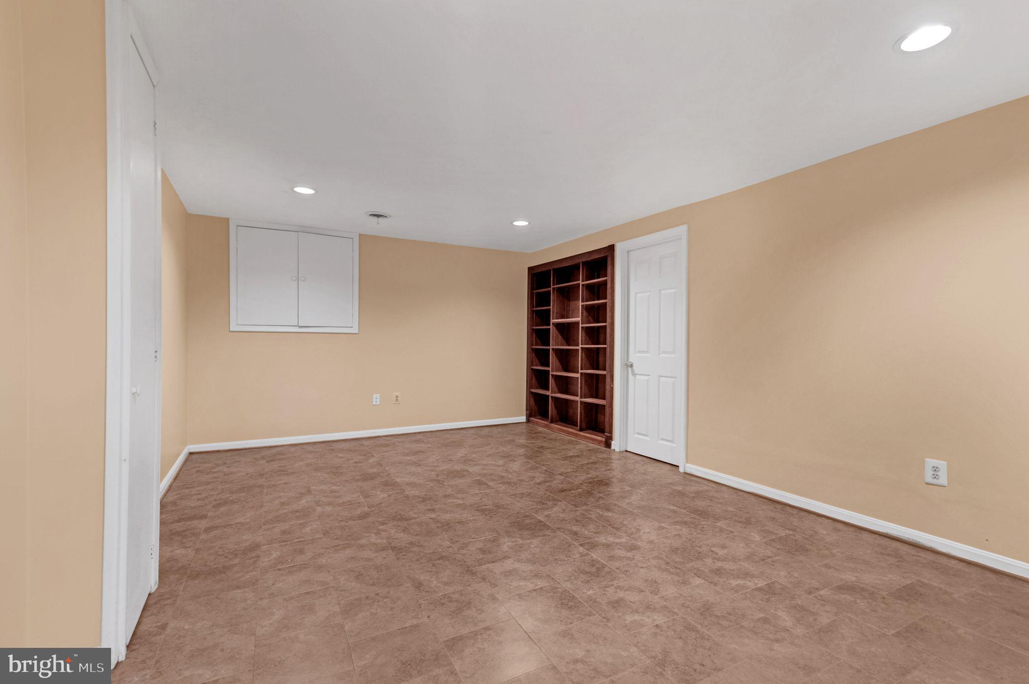 14422 Pebblestone Drive Silver Spring, MD 20905 - Photo 29 of 37 an empty room with bookshelf and a window