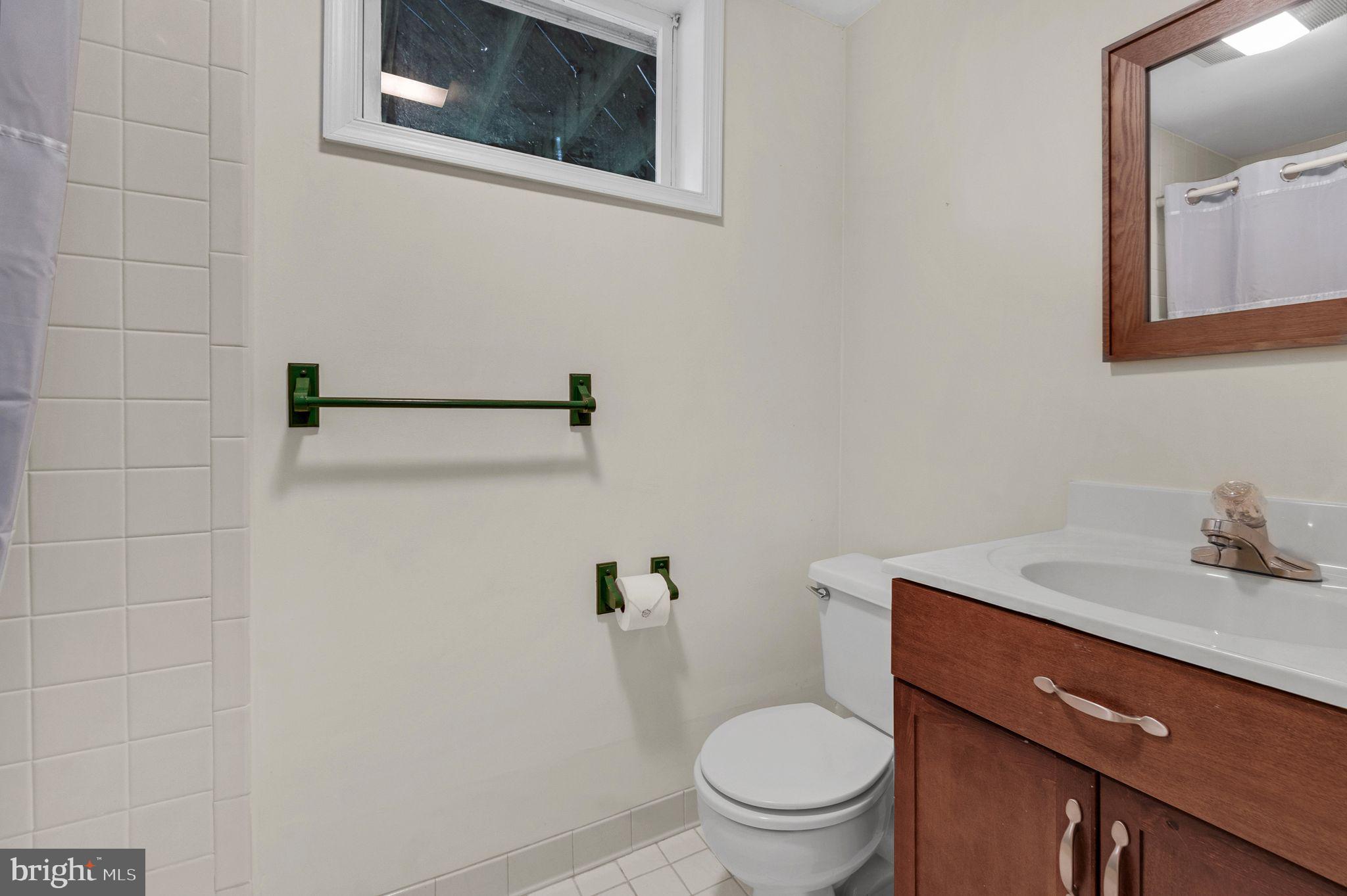 14422 Pebblestone Drive Silver Spring, MD 20905 - Photo 30 of 37 a bathroom with a toilet sink and mirror
