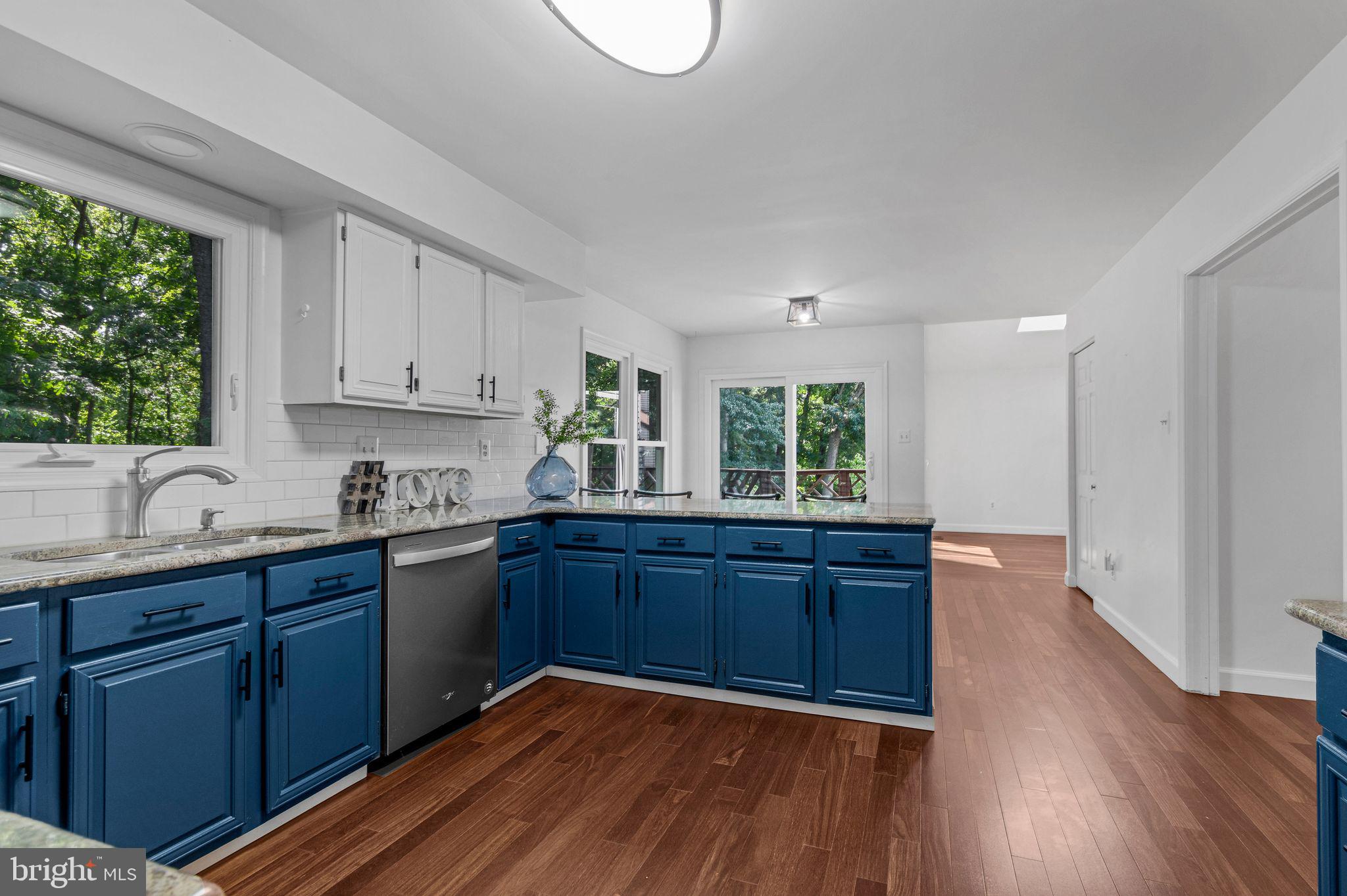 14422 Pebblestone Drive Silver Spring, MD 20905 - Photo 3 of 37 a kitchen with granite countertop wooden floors and sink