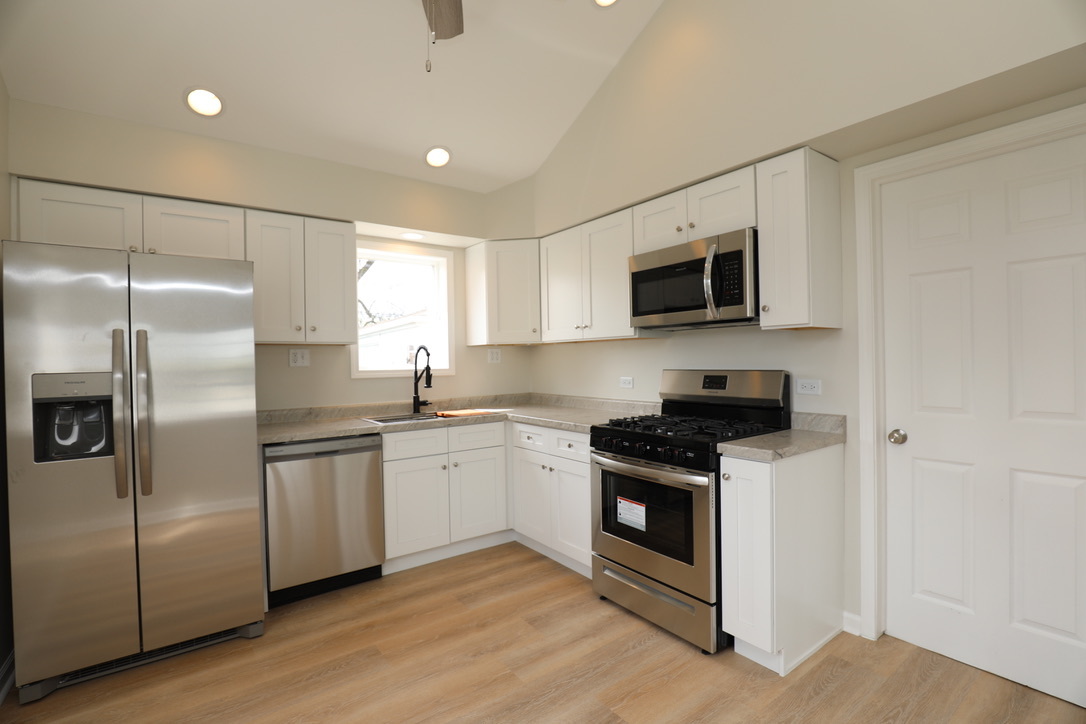 2207 175th Street Homewood, IL 60430 - Photo 2 of 13 a kitchen with stainless steel appliances granite countertop a stove a refrigerator and a microwave