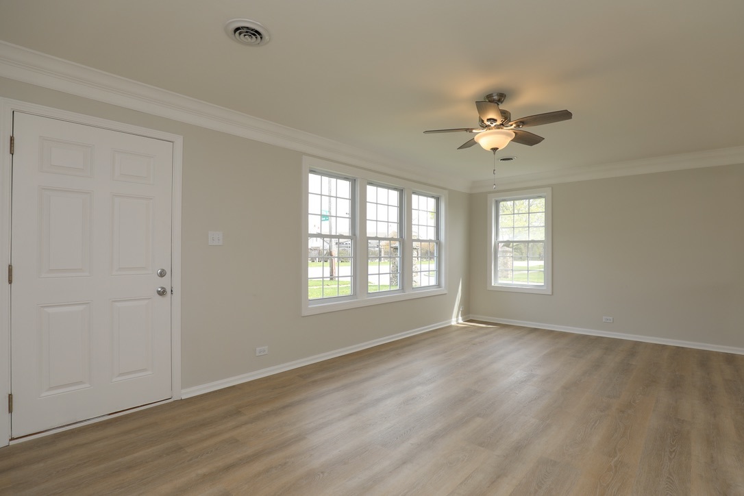 2207 175th Street Homewood, IL 60430 - Photo 3 of 13 a view of an empty room with a window and wooden floor