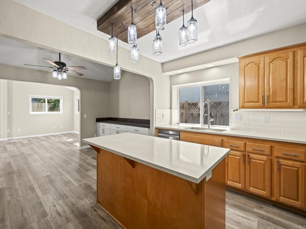 726 Fredricks Avenue Oceanside, CA 92058 - Photo 11 of 38 a large white kitchen with wooden floor