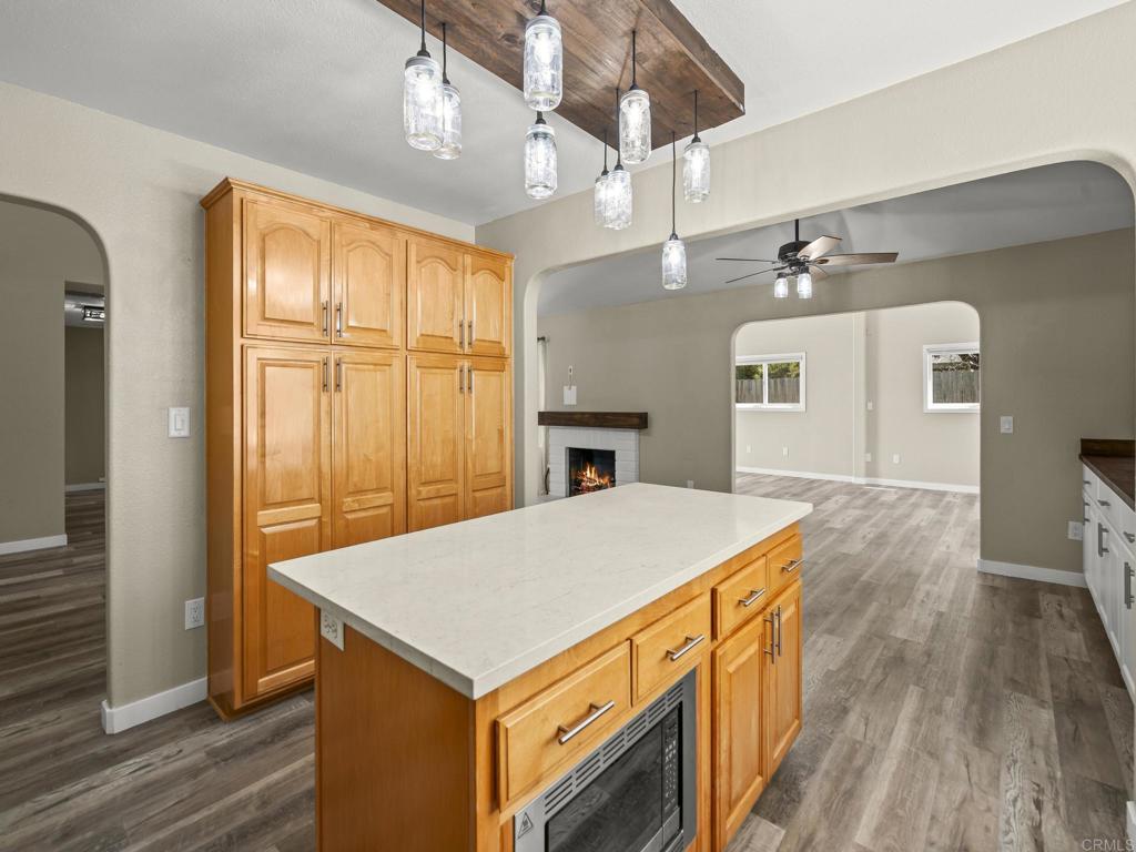 726 Fredricks Avenue Oceanside, CA 92058 - Photo 12 of 38 a kitchen that has a microwave a sink and a stove with wooden floor