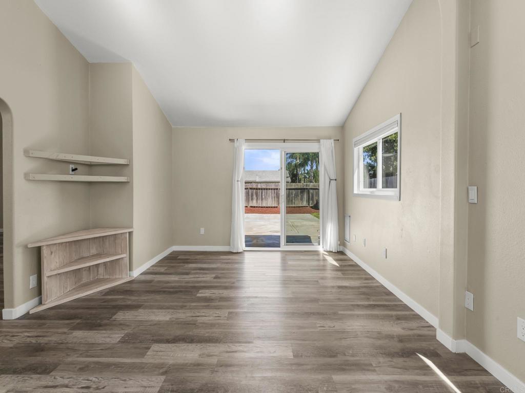 726 Fredricks Avenue Oceanside, CA 92058 - Photo 16 of 38 a view of an empty room with wooden floor and a window