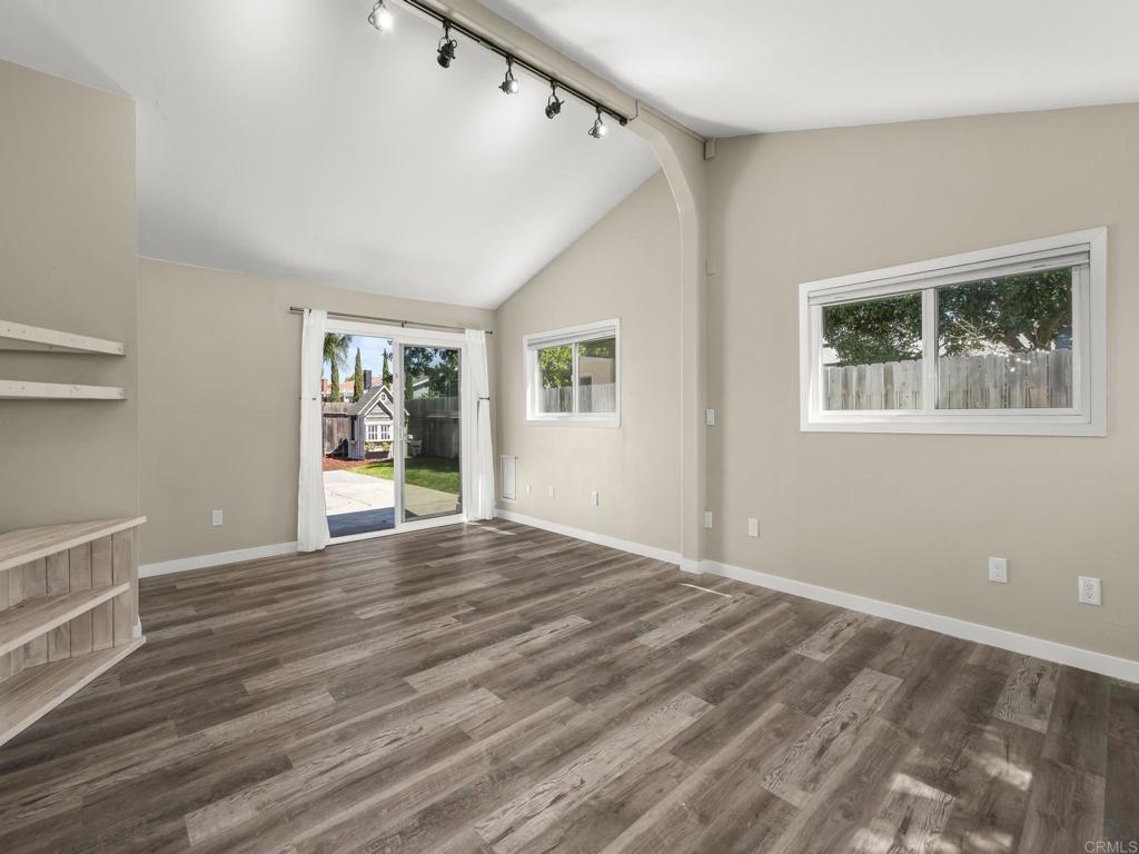 726 Fredricks Avenue Oceanside, CA 92058 - Photo 17 of 38 a view of an empty room with wooden floor and a window