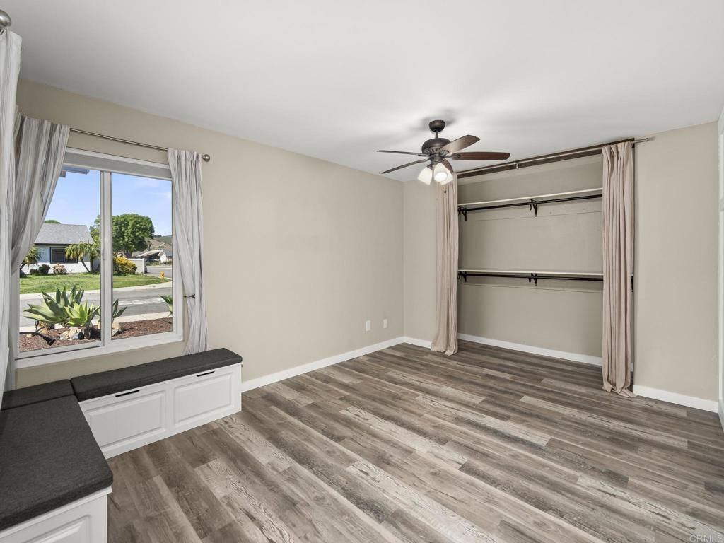 726 Fredricks Avenue Oceanside, CA 92058 - Photo 18 of 38 a view of a room with wooden floor and a ceiling fan