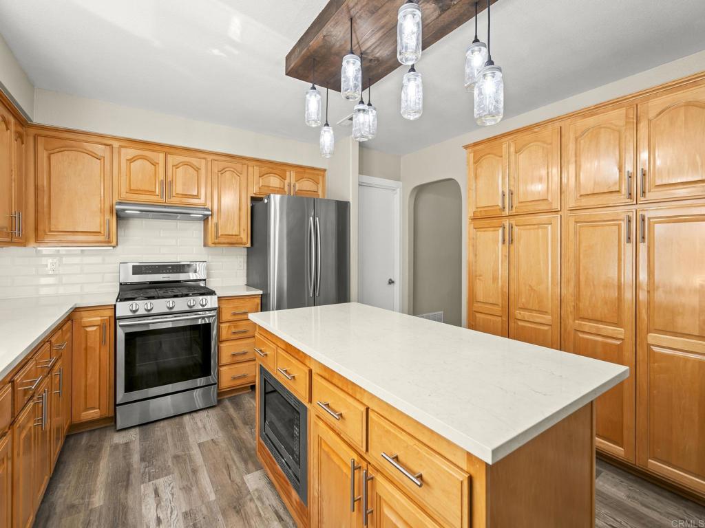 726 Fredricks Avenue Oceanside, CA 92058 - Photo 8 of 38 a kitchen with stainless steel appliances a stove a refrigerator and a sink