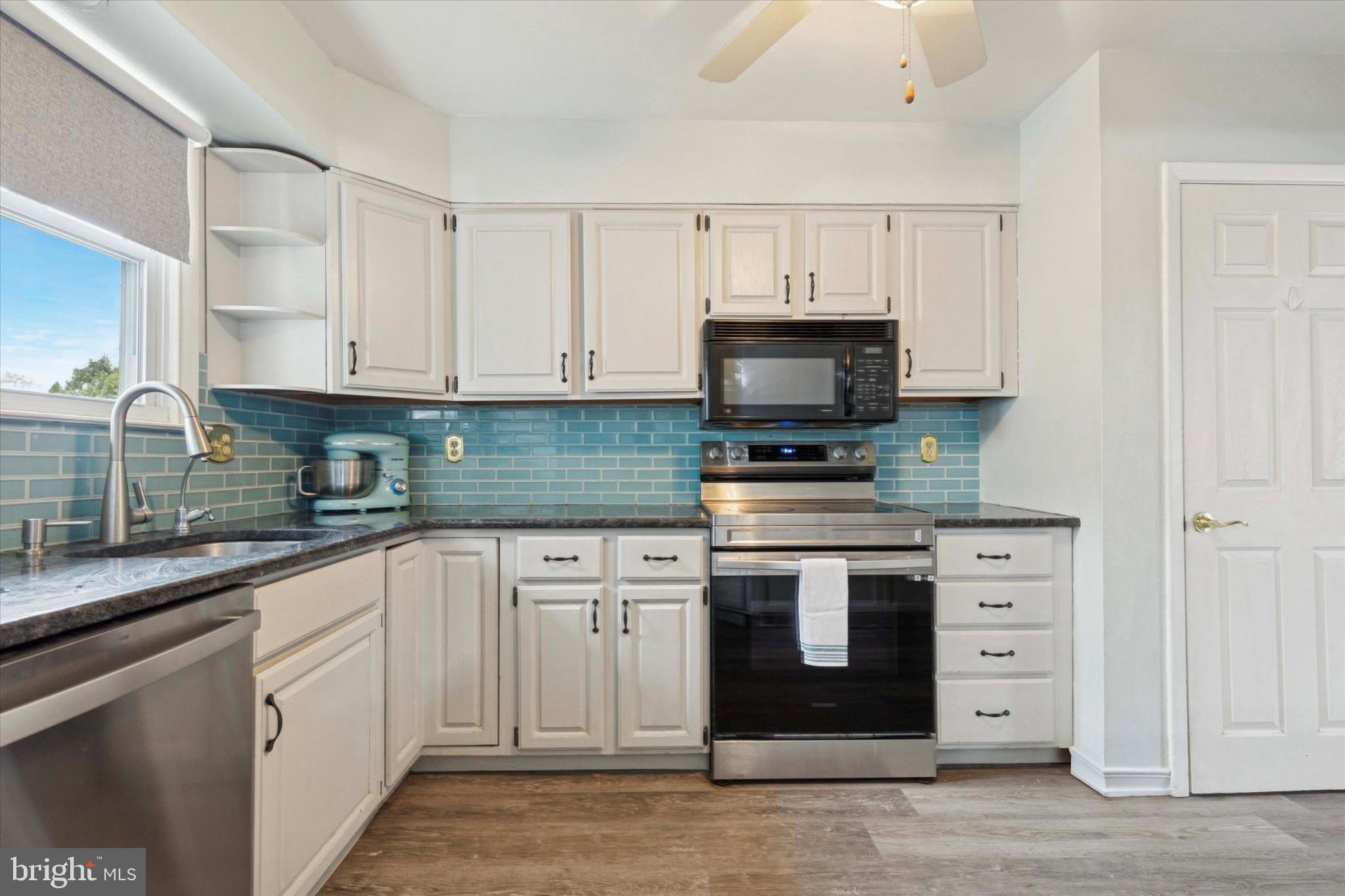 108 Devon Road Chalfont, PA 18914 - Photo 6 of 30 a kitchen with white cabinets and stainless steel appliances