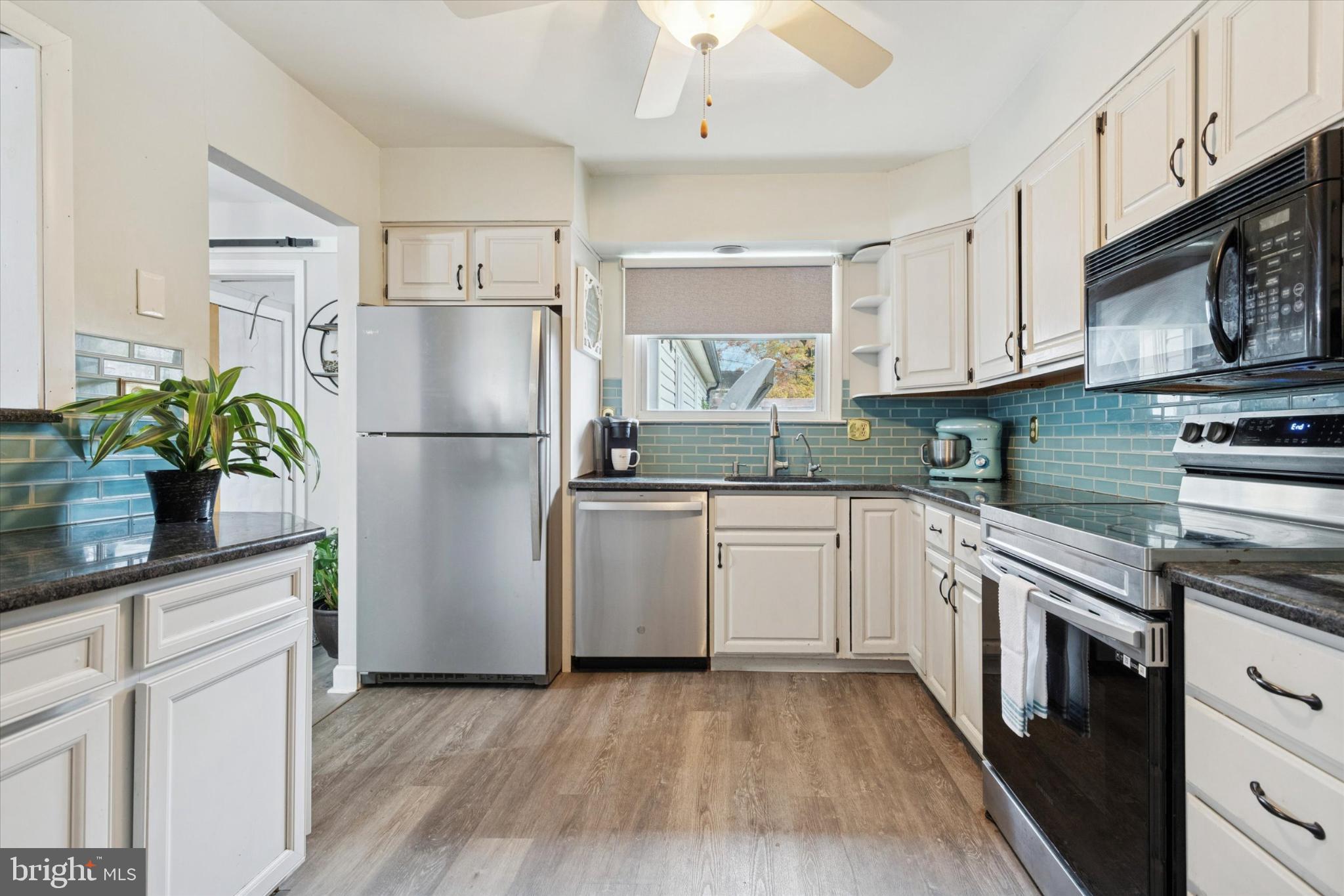108 Devon Road Chalfont, PA 18914 - Photo 8 of 30 a kitchen with a refrigerator a microwave a sink and cabinets