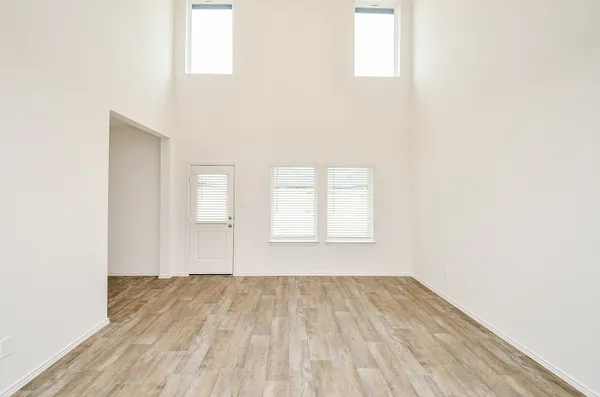 a view of a kitchen with kitchen island a sink wooden floor and a living room view