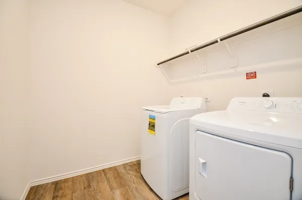 a view of an empty room with a fireplace and a window