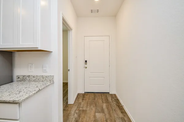 an empty room with wooden floor and a window