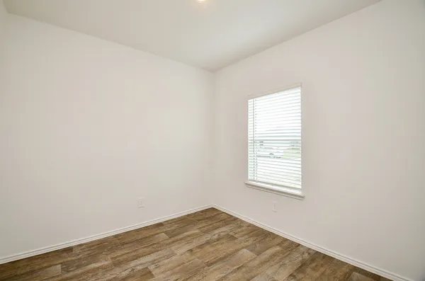 a kitchen with a sink a refrigerator and wooden floor