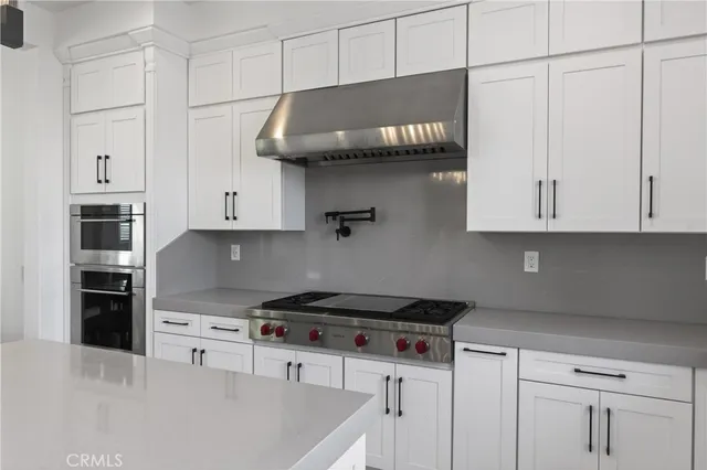 a kitchen with stainless steel appliances granite countertop a stove and a refrigerator