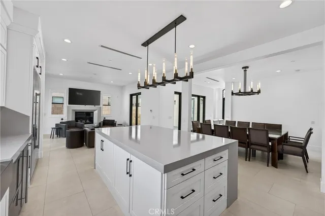 a large white kitchen with a table and chairs