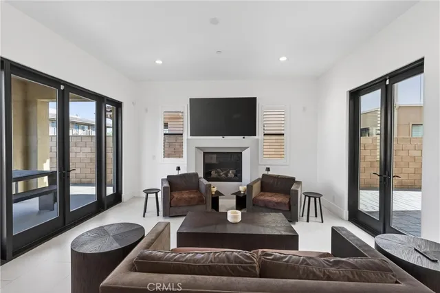 a living room with furniture large windows and a flat screen tv