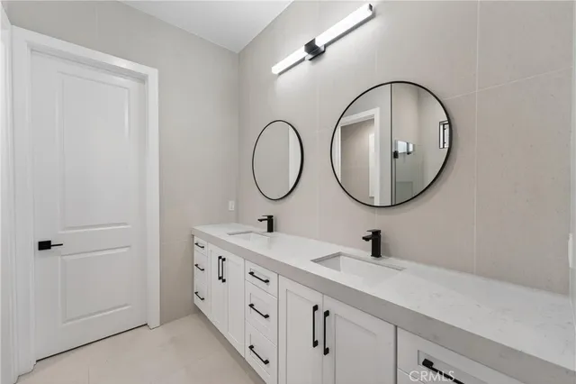 a bathroom with a double vanity sink and a mirror
