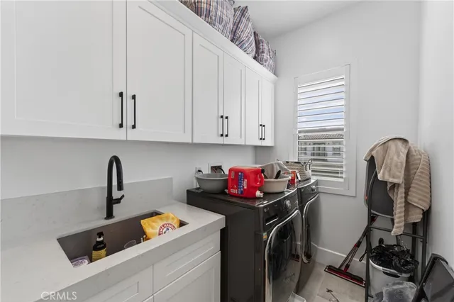 a kitchen with a sink a stove and cabinets