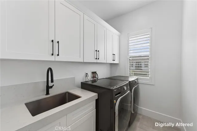 a view of a kitchen with sink dryer and washer