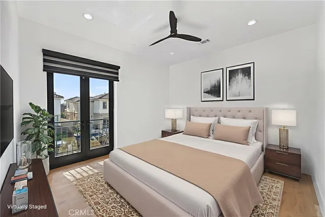 a bedroom with a large bed and a potted plant