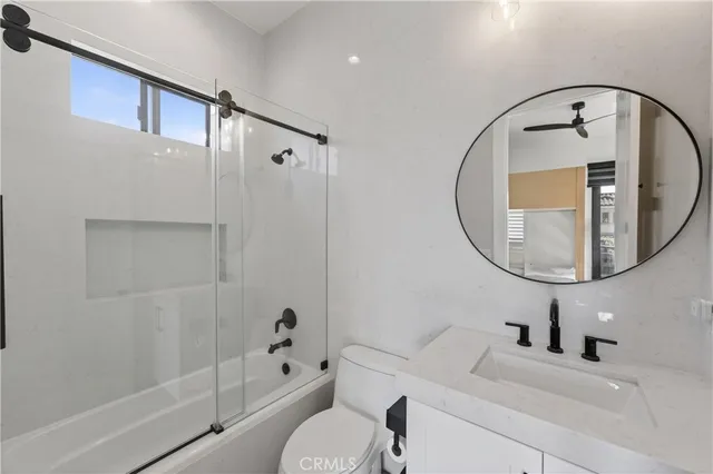 a bathroom with a toilet a sink and bathtub