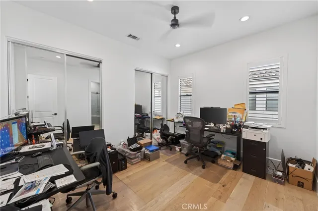 a view of a workspace with furniture and a window