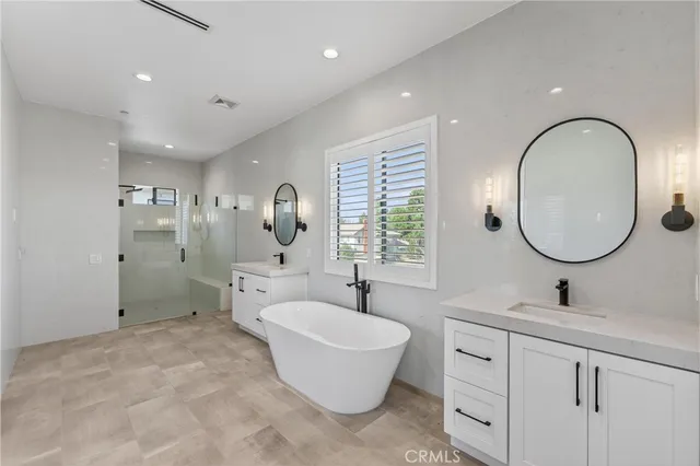 a bathroom with a toilet a sink a mirror and a window