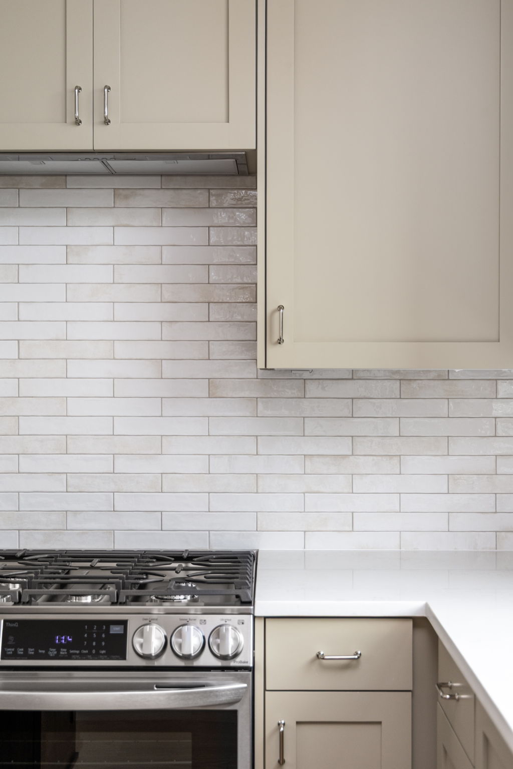 408 Linden Street, Unit B Austin, TX 78702 - Photo 12 of 40 Kitchen with stainless steel range with gas cooktop, backsplash, range hood, and light stone countertops