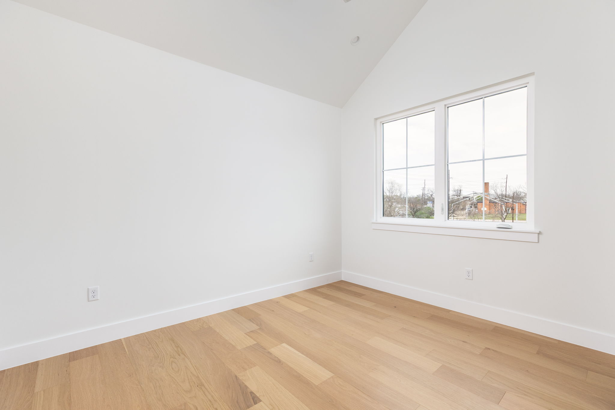 408 Linden Street, Unit B Austin, TX 78702 - Photo 20 of 40 Unfurnished room featuring light wood-style flooring and lofted ceiling