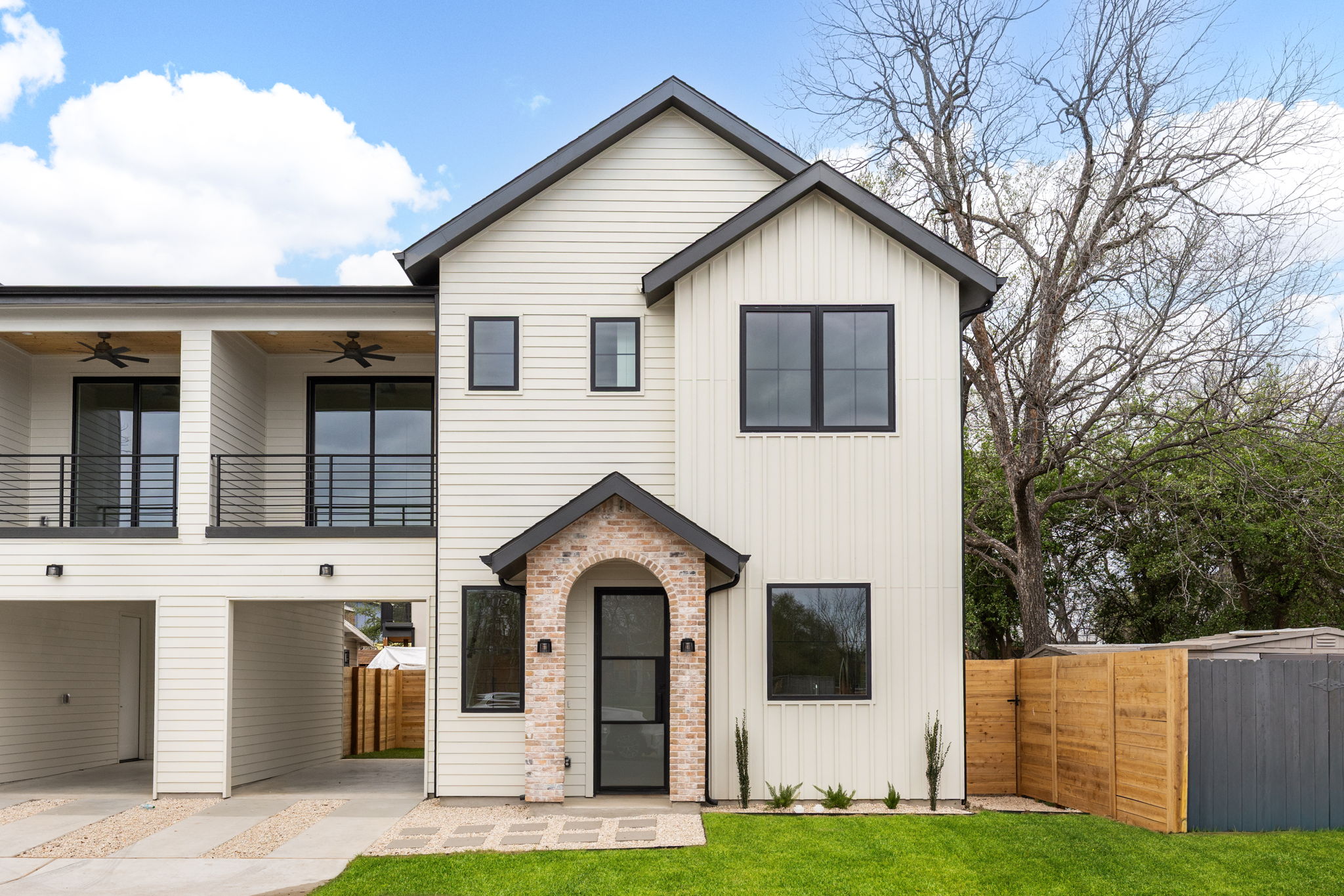 408 Linden Street, Unit B Austin, TX 78702 - Photo 4 of 40 View of front facade featuring board and batten siding, ceiling fan, a balcony, and a gate