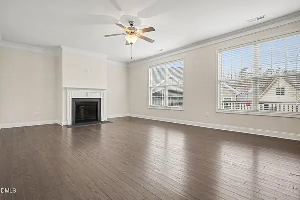 a large kitchen with stainless steel appliances kitchen island granite countertop a stove a refrigerator a sink a oven and a wooden floor