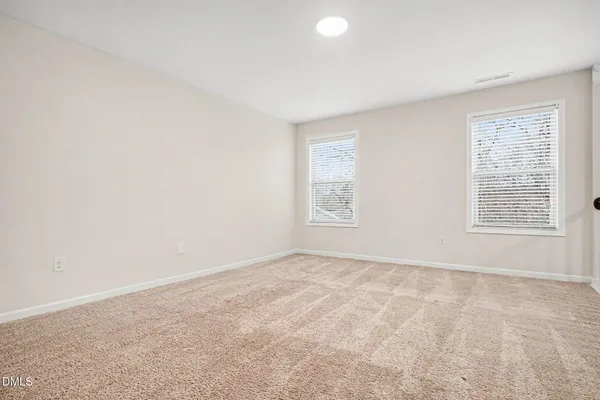 a bathroom with a granite countertop sink toilet and mirror