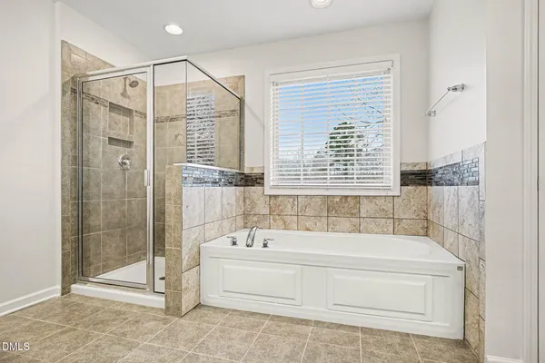 a bathroom with a tub a sink and a shower